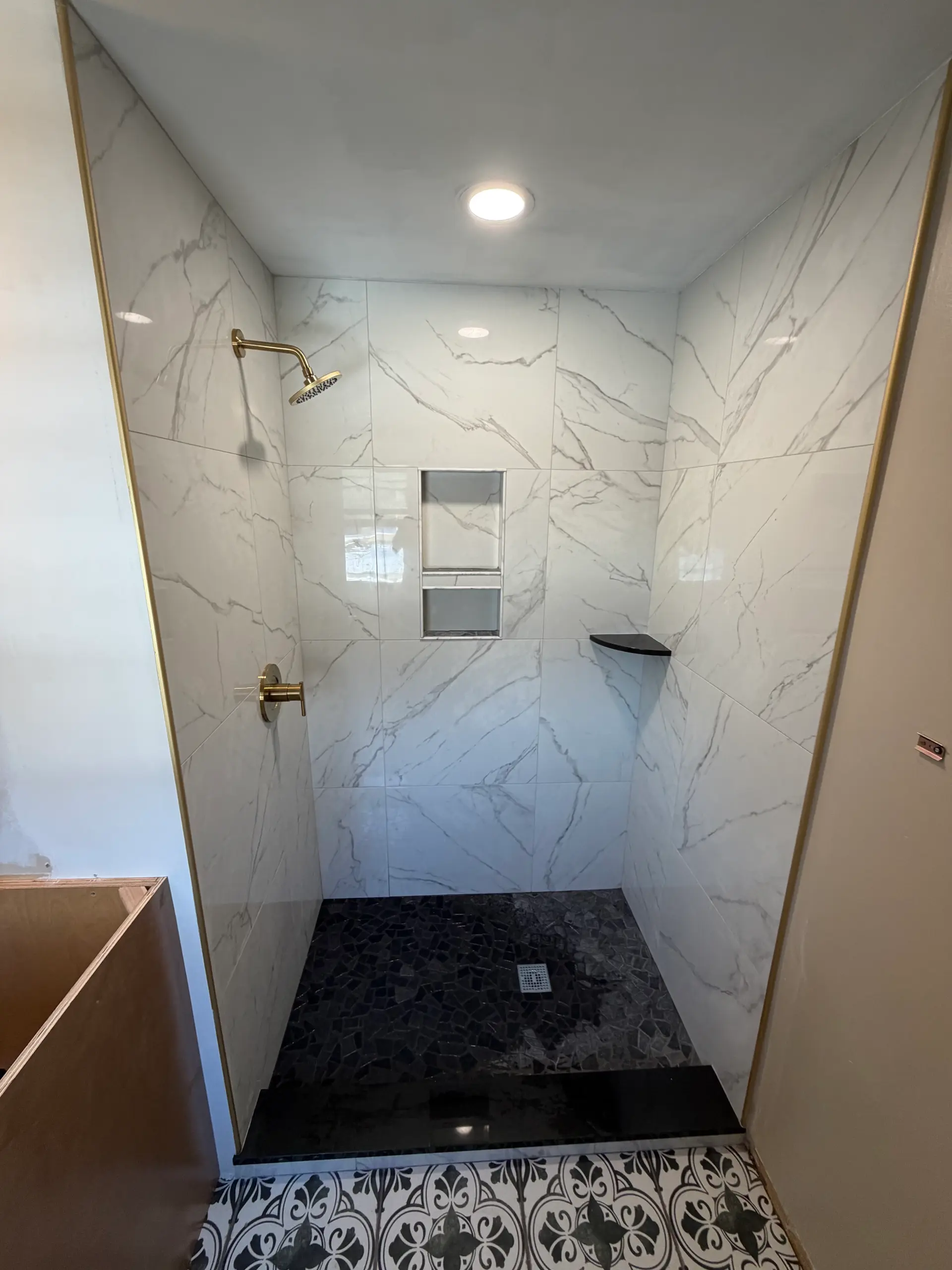 Bathroom tile installation — floor-to-ceiling tile design