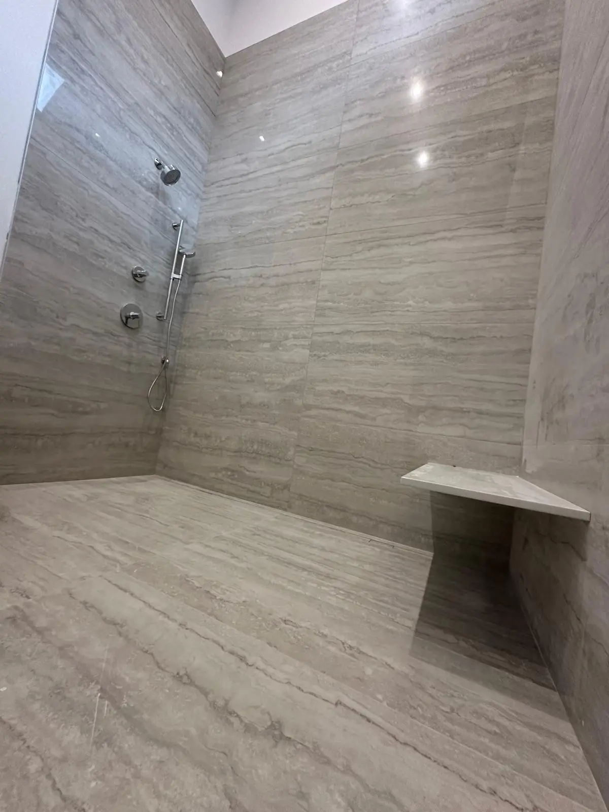 Bathroom floor tile installation with herringbone pattern
